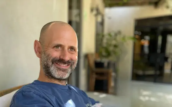 Howard, Nelawa's founder, smiling in a blue t-shirt